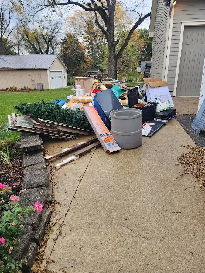 Dumpster being loaded with debris for Roofing Dumpster Rental in Granville